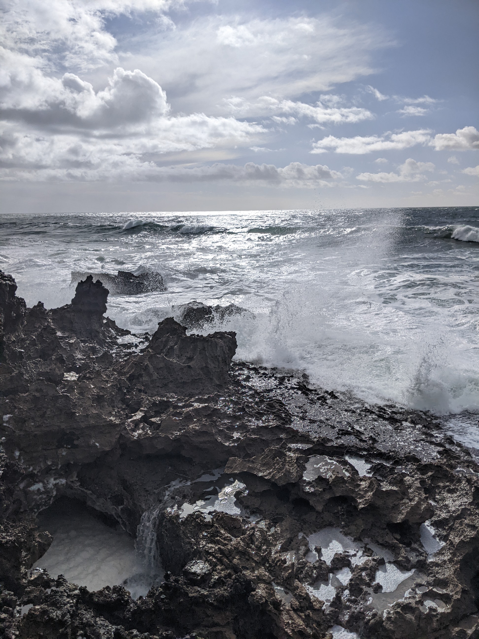 a rocky beach with crashing waves